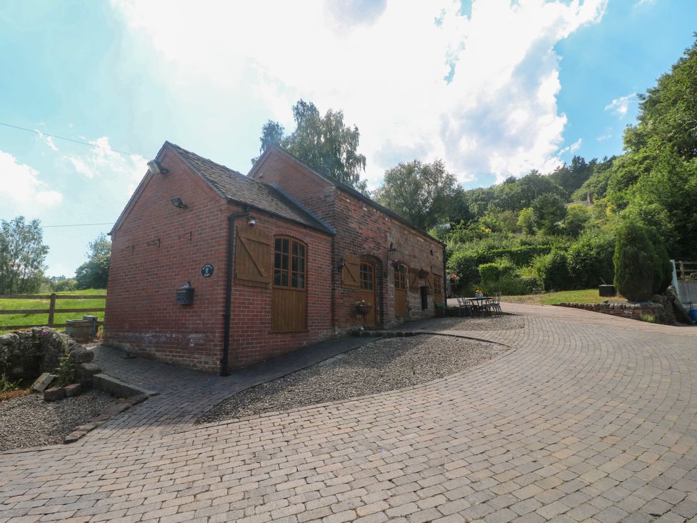 A barn with a pathway and trees at Bluebell Barn Stoke-on-Trent