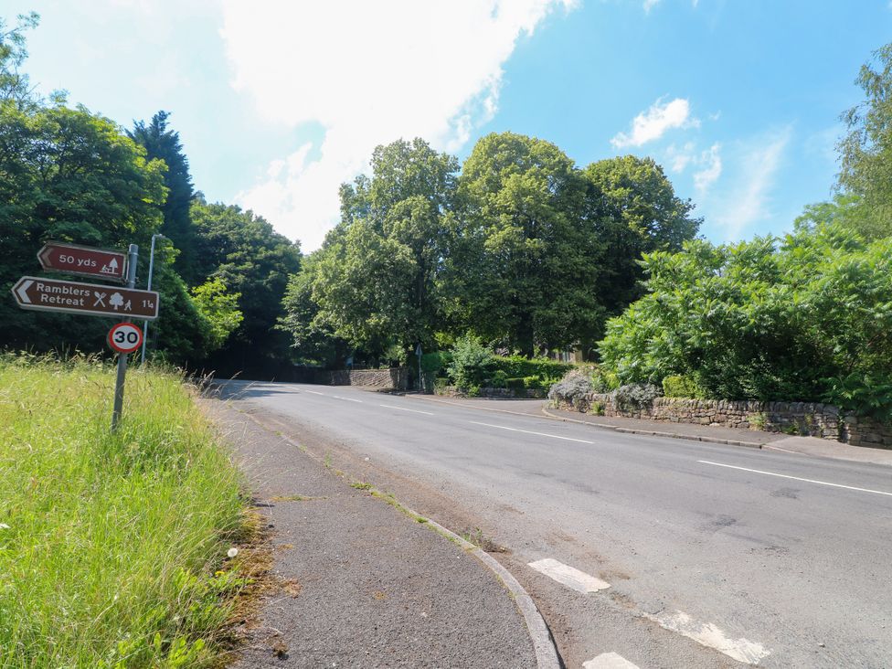 A road with a signpost and trees at Bluebell Barn Stoke-on-Trent