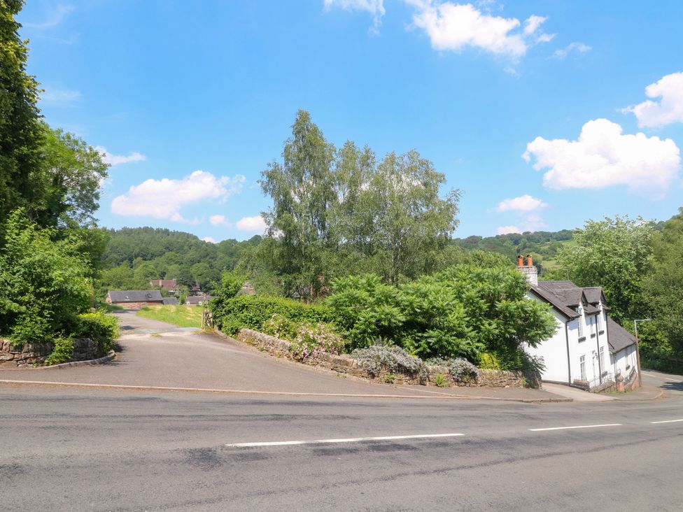 A view of a house surrounded by trees and bushes at Bluebell Barn Stoke-on-Trent