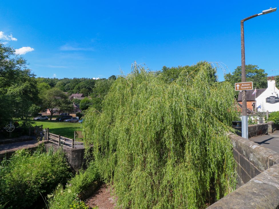 A view of a willow tree and a road sign at Bluebell Barn Stoke-on-Trent