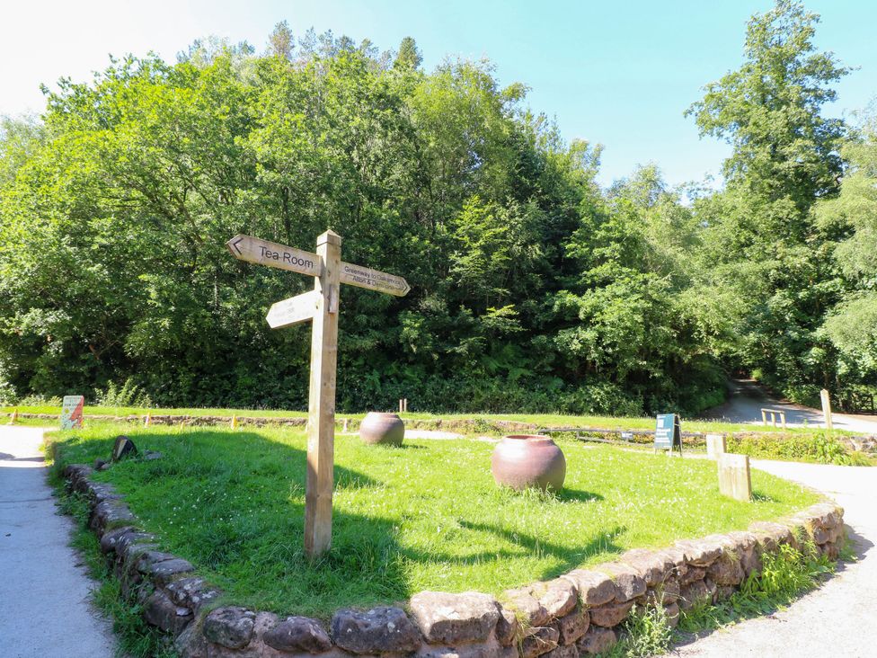 An outdoor area with a signpost and a garden at Bluebell Barn Stoke-on-Trent