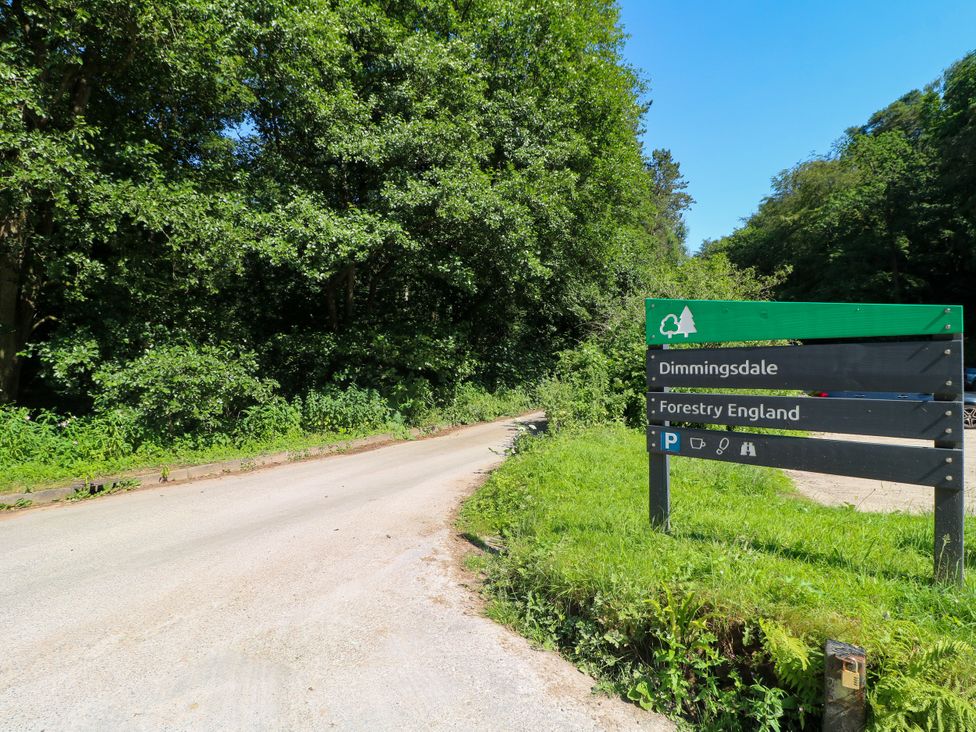 A sign for Dimmingsdale with trees and a road at Bluebell Barn Stoke-on-Trent