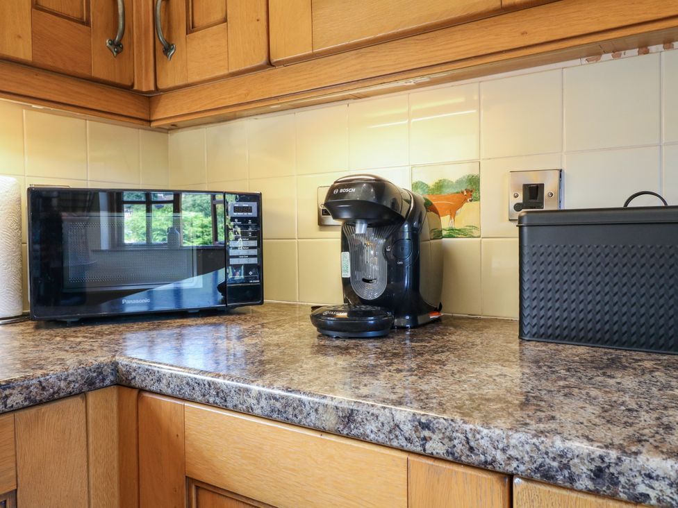 A kitchen with a microwave and coffee machine at Bluebell Barn in Oakamoor