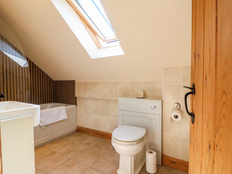 A bathroom with a shower and a sink at Bluebell Barn in Oakamoor