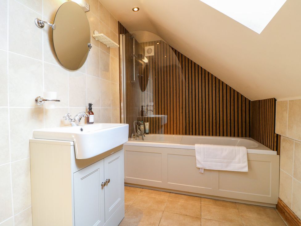 A bathroom with a sink and bathtub at Bluebell Barn in Oakamoor