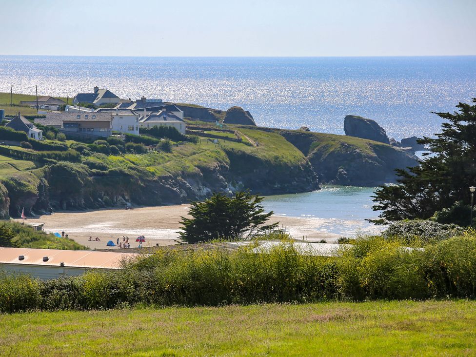 A beach and coastline with houses at Porthcothan House in St Merryn