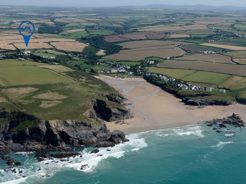 An aerial view of a beach and surrounding farmland at Porthcothan House in St Merryn