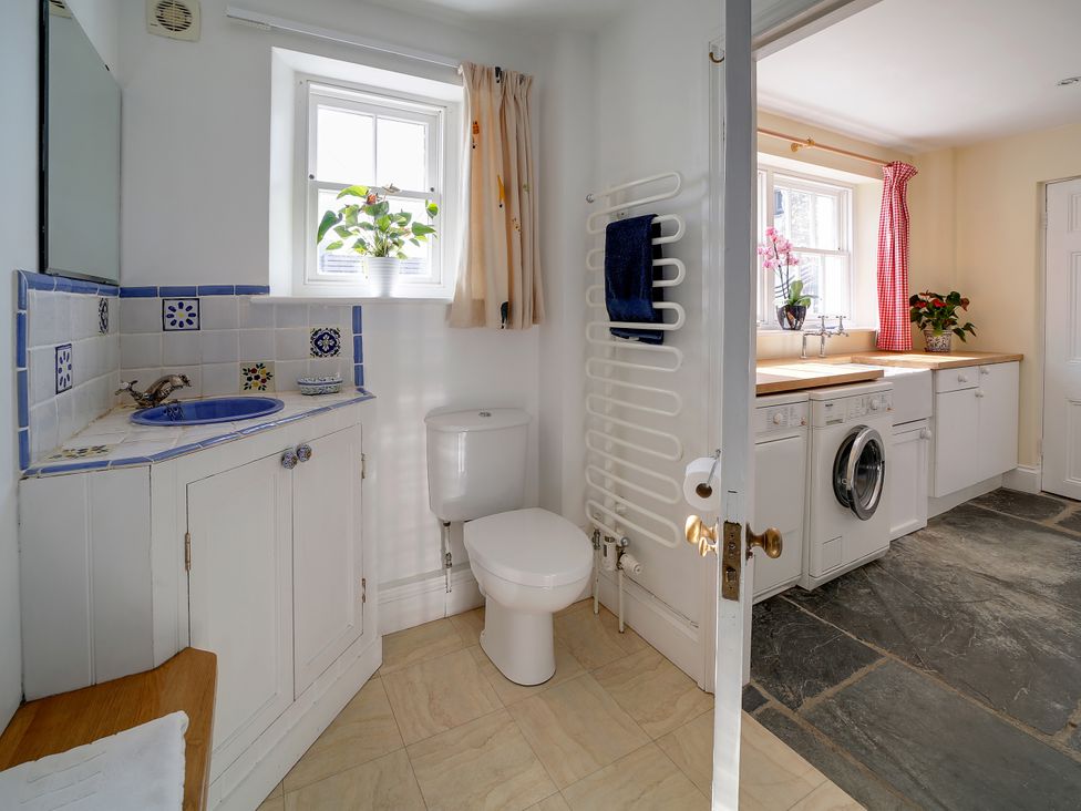 A bathroom with sink and toilet at Porthcothan House in Porthcothan