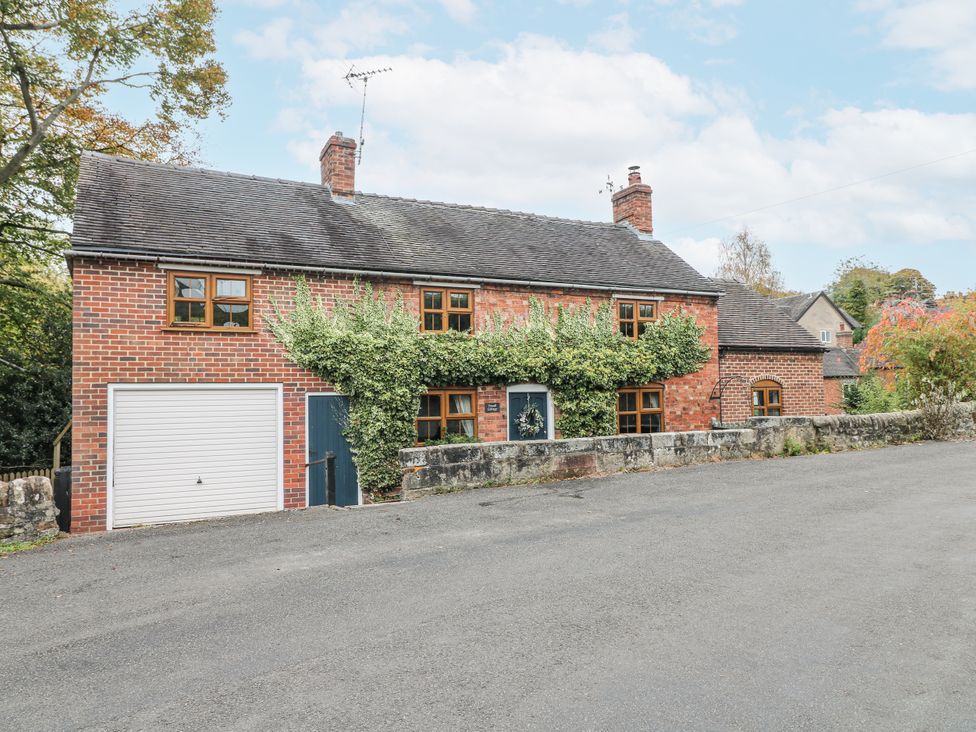 A brick house with a garage and garden at Yoxall Cottage Stoke-on-Trent