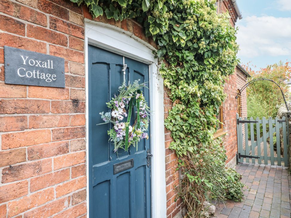 A blue door with a wreath and nameplate at Yoxall Cottage in Stoke-on-Trent