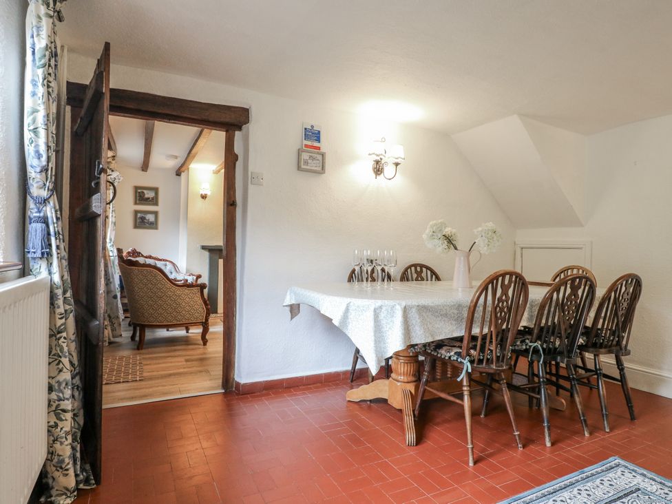 A dining room with a table and chairs at Yoxall Cottage in Stoke-on-Trent