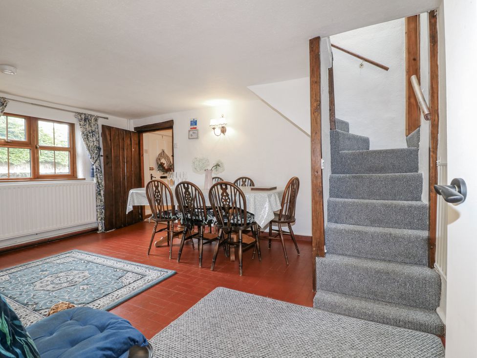 A dining room with a table and chairs at Yoxall Cottage in Stoke-on-Trent