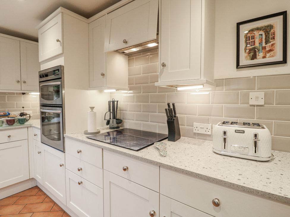 A kitchen with cabinets and appliances at Yoxall Cottage Stoke-on-Trent