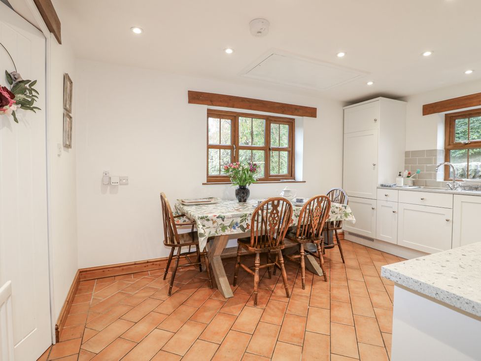 A kitchen with a table and chairs at Yoxall Cottage in Stoke-on-Trent