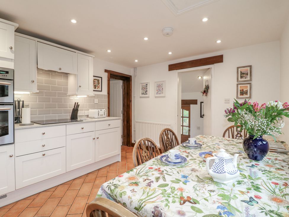 A kitchen with a dining table and chairs at Yoxall Cottage Stoke-on-Trent