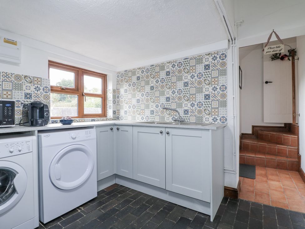 A kitchen with a washing machine and tumble dryer at Yoxall Cottage in Stoke-on-Trent