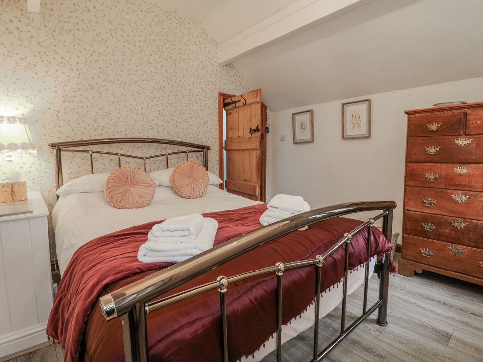 A bedroom with a bed and wooden furniture at Yoxall Cottage Stoke-on-Trent