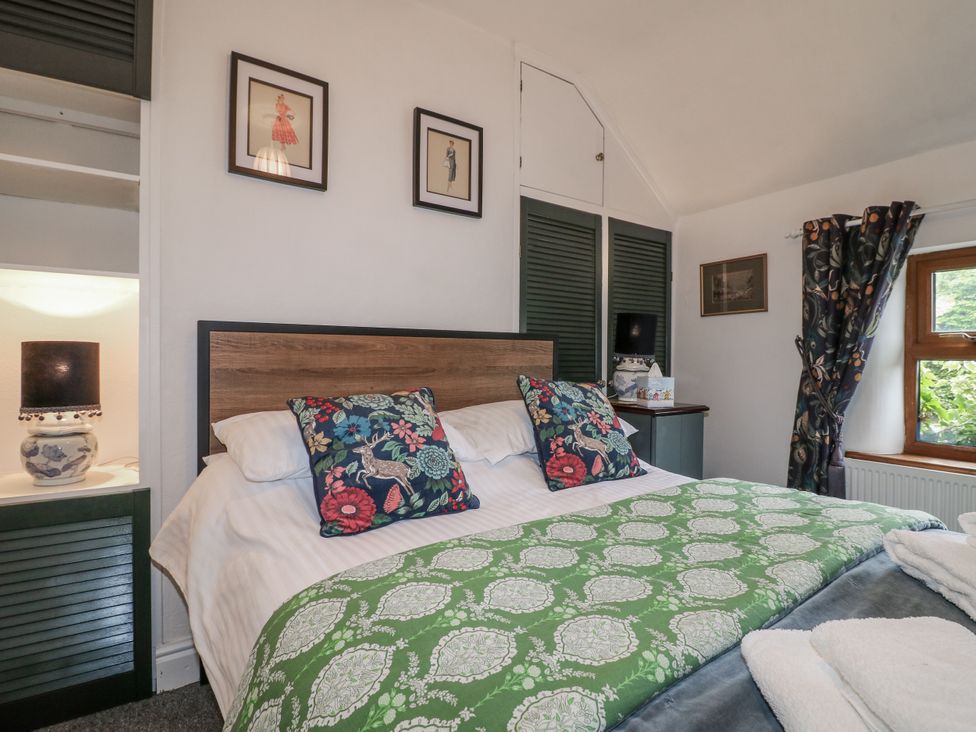 A bedroom with a bed and decorative pillows at Yoxall Cottage in Stoke-on-Trent