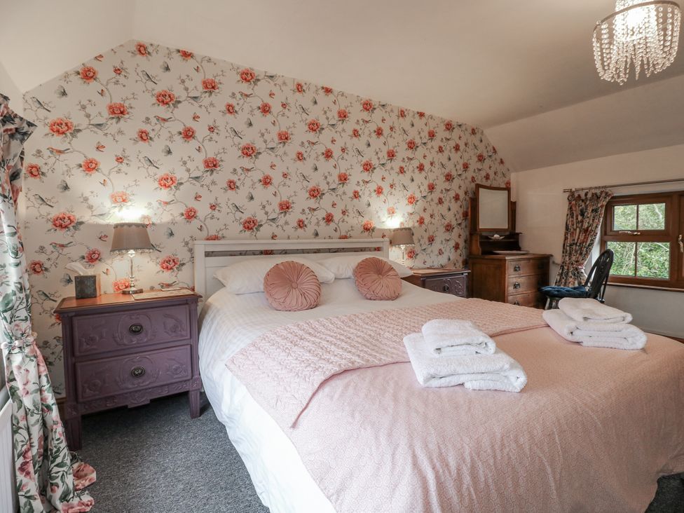 A bedroom with a bed and nightstands at Yoxall Cottage Stoke-on-Trent