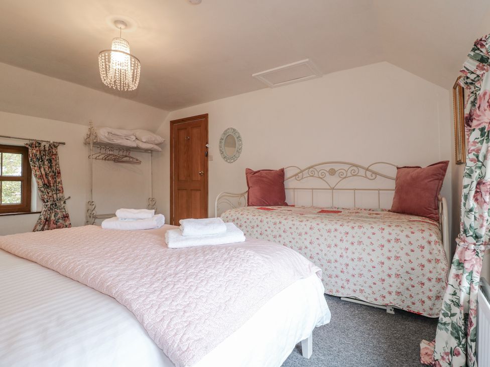 A bedroom with two beds and a window at Yoxall Cottage Stoke-on-Trent
