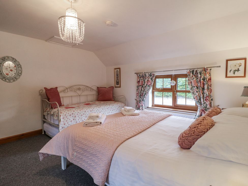 A bedroom with two beds and a window at Yoxall Cottage in Stoke-on-Trent
