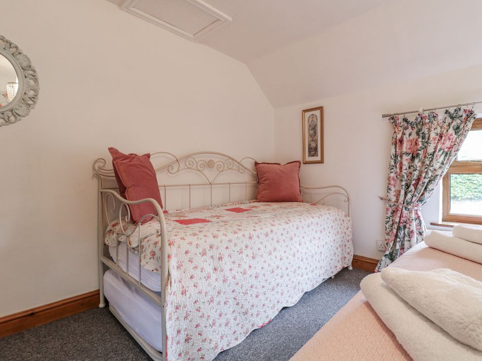 A bedroom with a bed and mirror at Yoxall Cottage Stoke-on-Trent