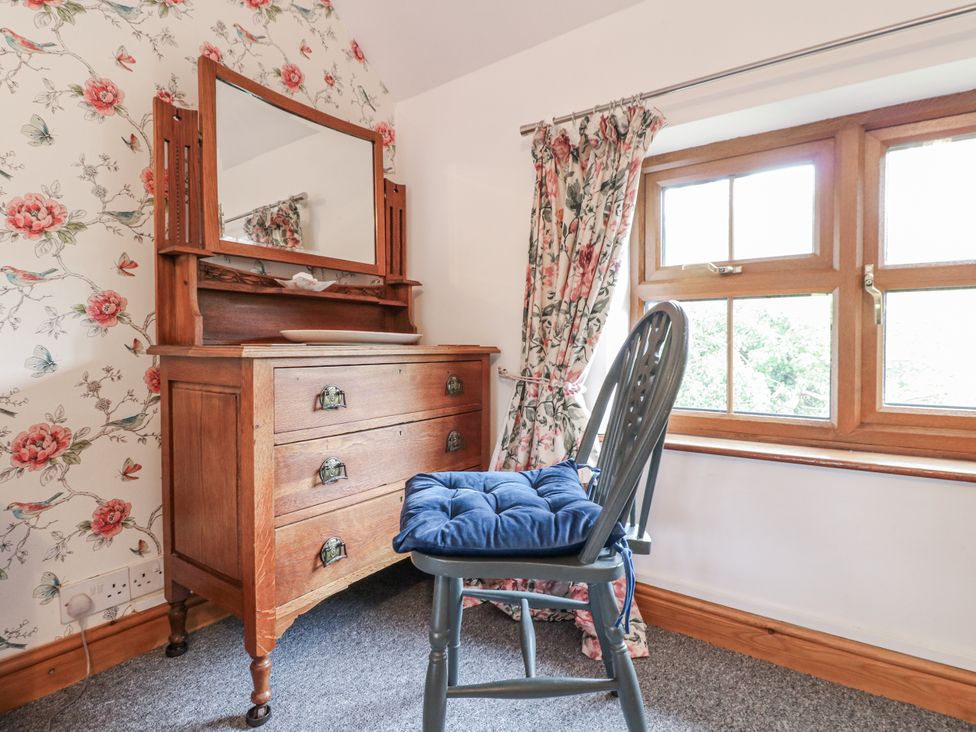 A bedroom with a dresser and chair at Yoxall Cottage Stoke-on-Trent