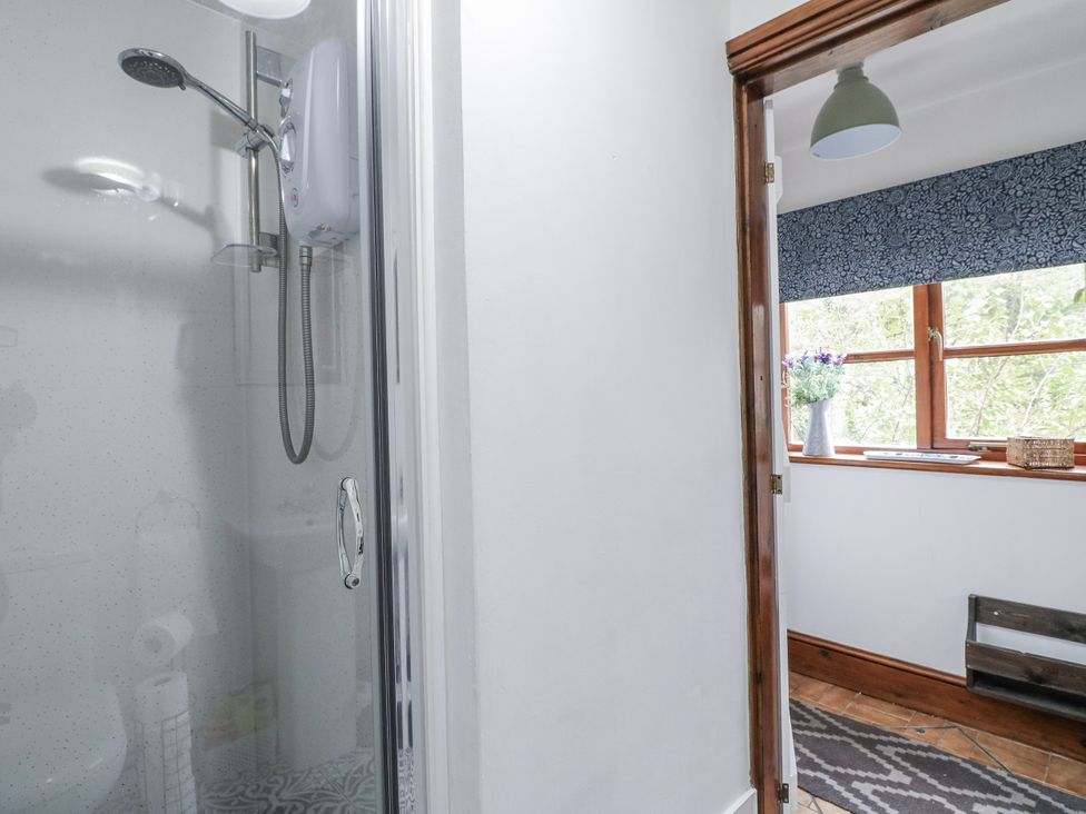 A bathroom featuring a shower and a window at Yoxall Cottage in Stoke-on-Trent