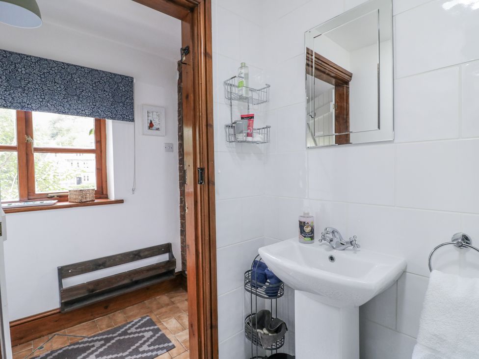 A bathroom with a sink and mirror at Yoxall Cottage in Stoke-on-Trent