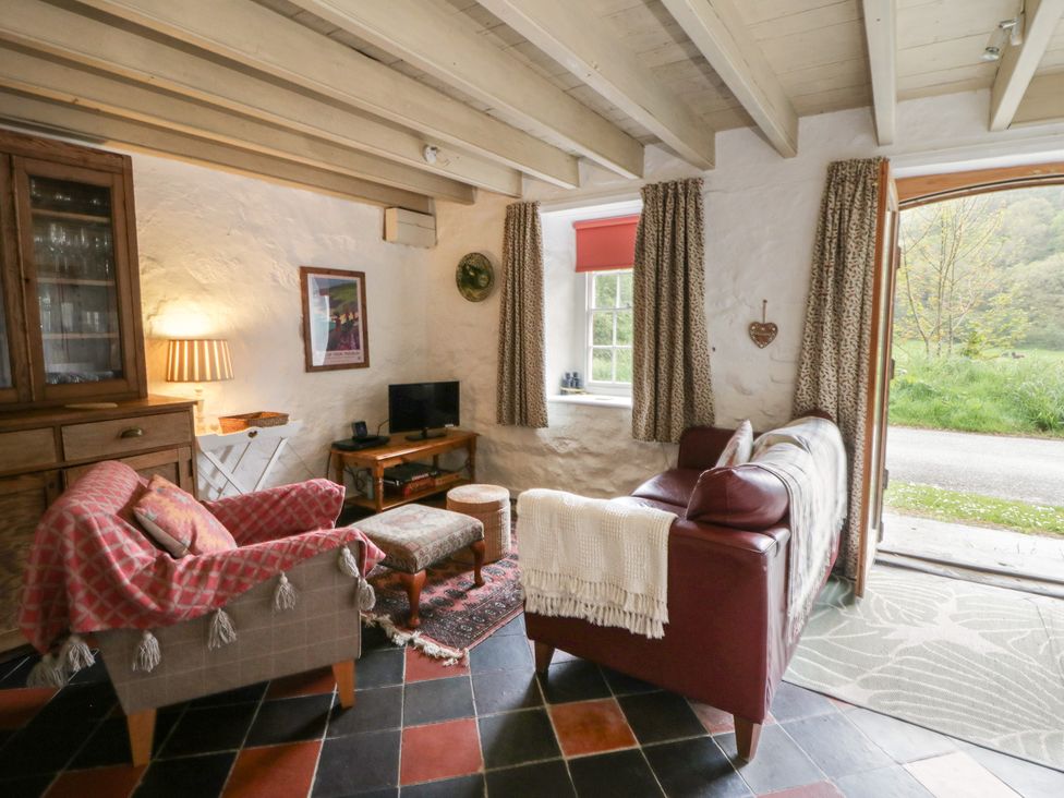 A living room with a sofa and television at Sycamore Vestry in Pontfaen near Fishguard