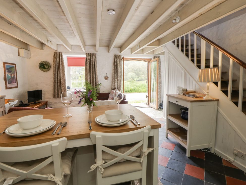 A living room with a dining table and chairs at Sycamore Vestry Pontfaen near Fishguard