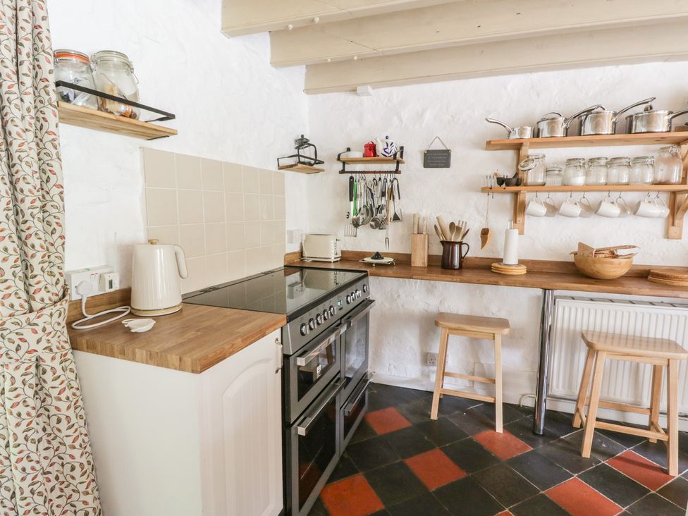 A kitchen with a stove and wooden counter at Sycamore Vestry in Pontfaen near Fishguard