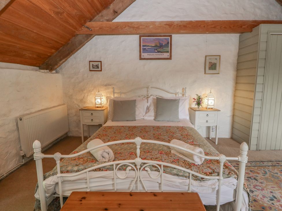 A bedroom with a bed and bedside tables at Sycamore Vestry in Pontfaen near Fishguard