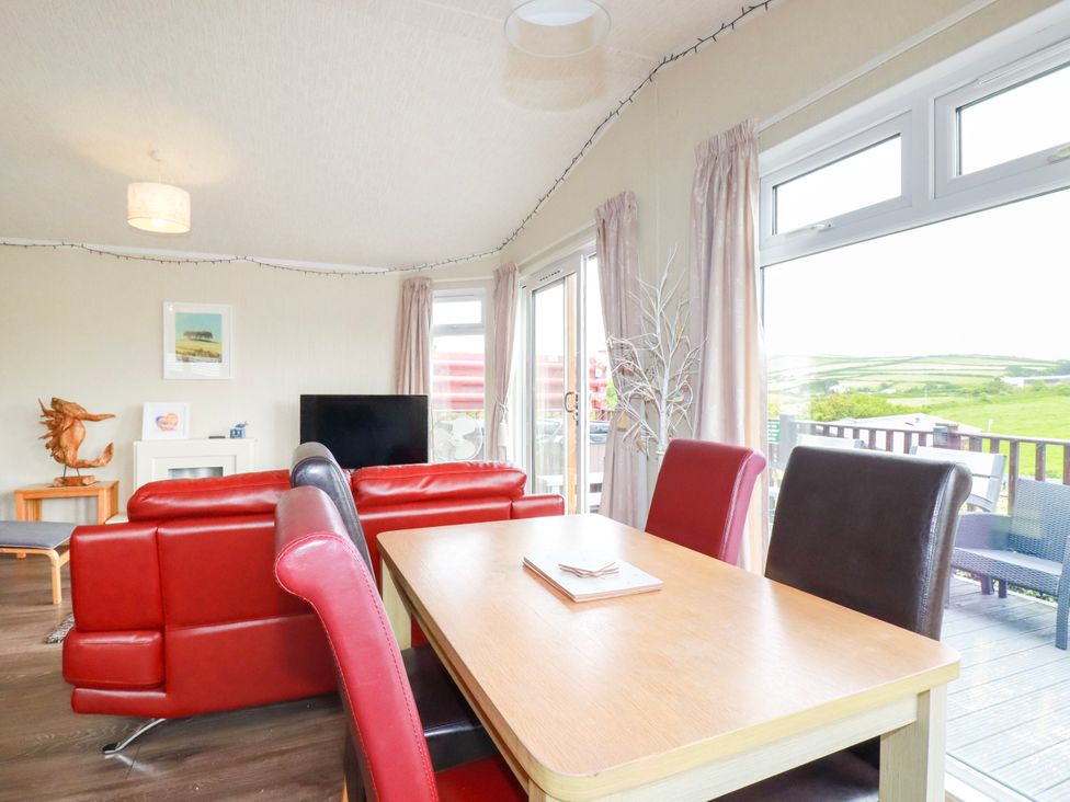 A living room with a dining table and sofa at Chi Prenn Byhan in Tintagel