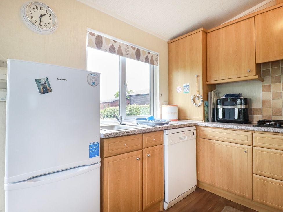 A kitchen with a fridge, sink, and dishwasher at Chi Prenn Byhan in Tintagel