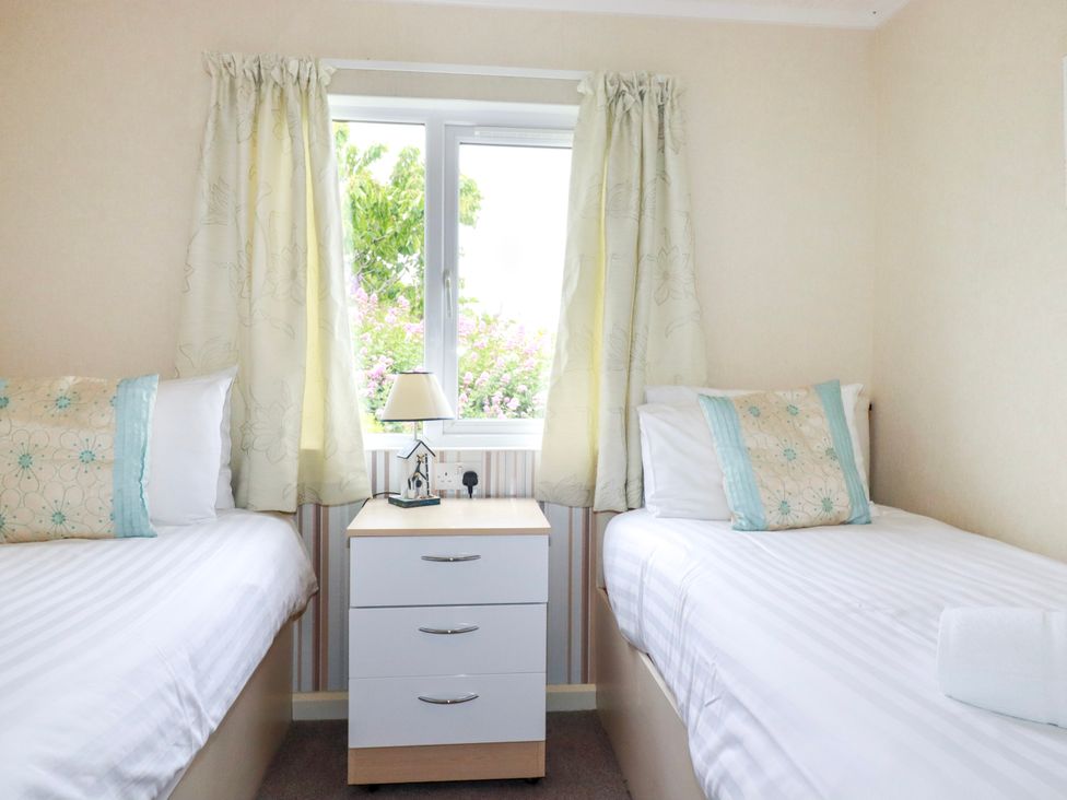 A bedroom with two twin beds and a window at Chi Prenn Byhan in Tintagel