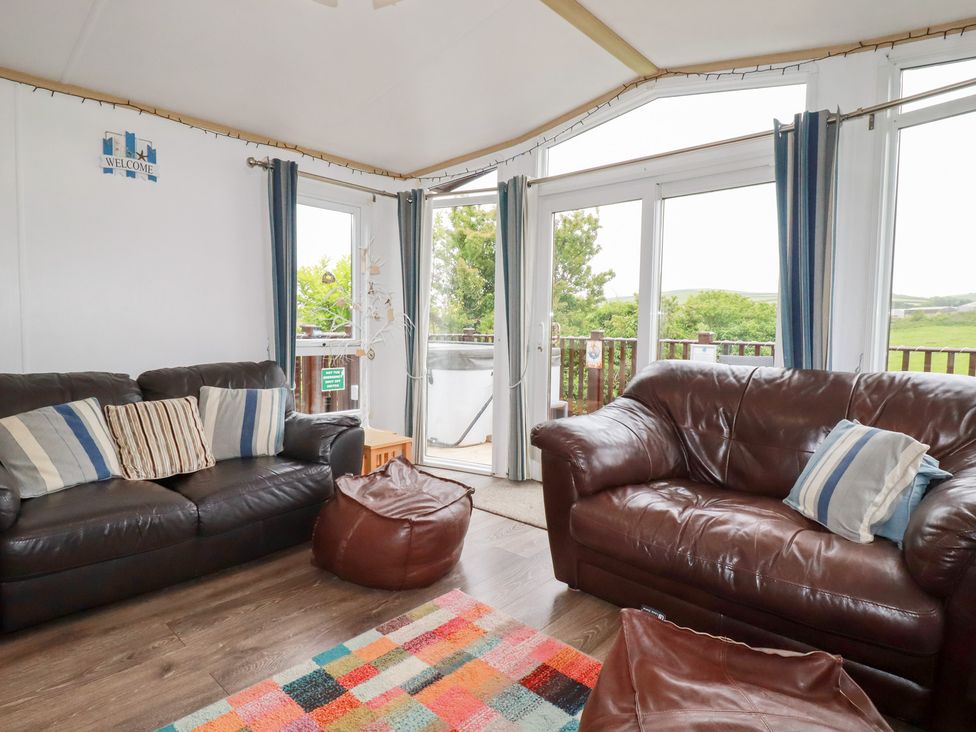 A living room with sofas and a bean bag at Orchard View in Bossiney near Tintagel