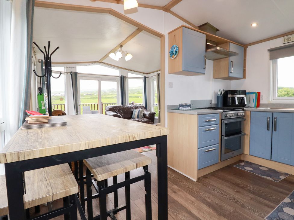 A kitchen with a table and chairs at Orchard View in Bossiney near Tintagel