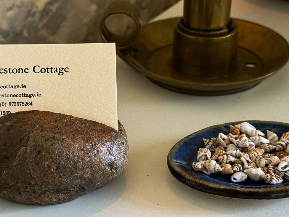 A business card holder with a card and shells at The Captain's Nest in Bunbeg, County Donegal