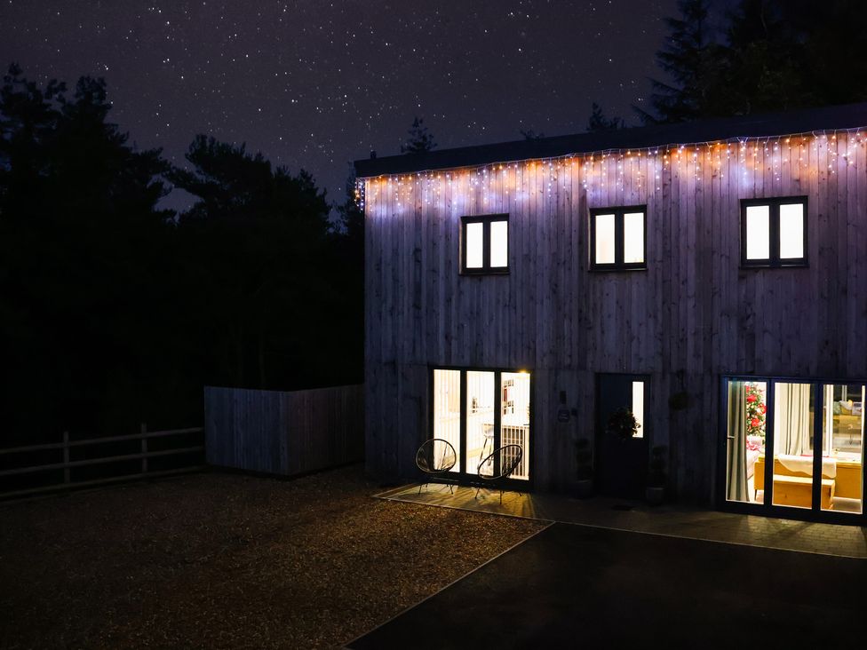 An exterior view of a building with lights at Stag Cottage in Lytchett Matravers