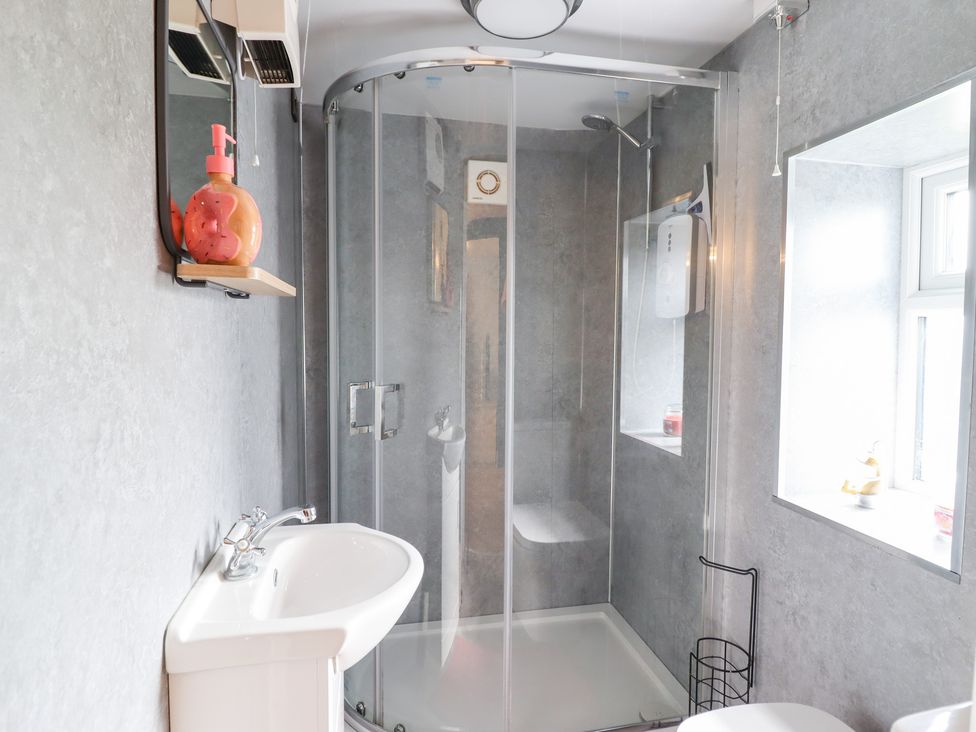 A bathroom with a shower and wash basin at Burgedin Locks Cottage near Arddleen Llandrinio