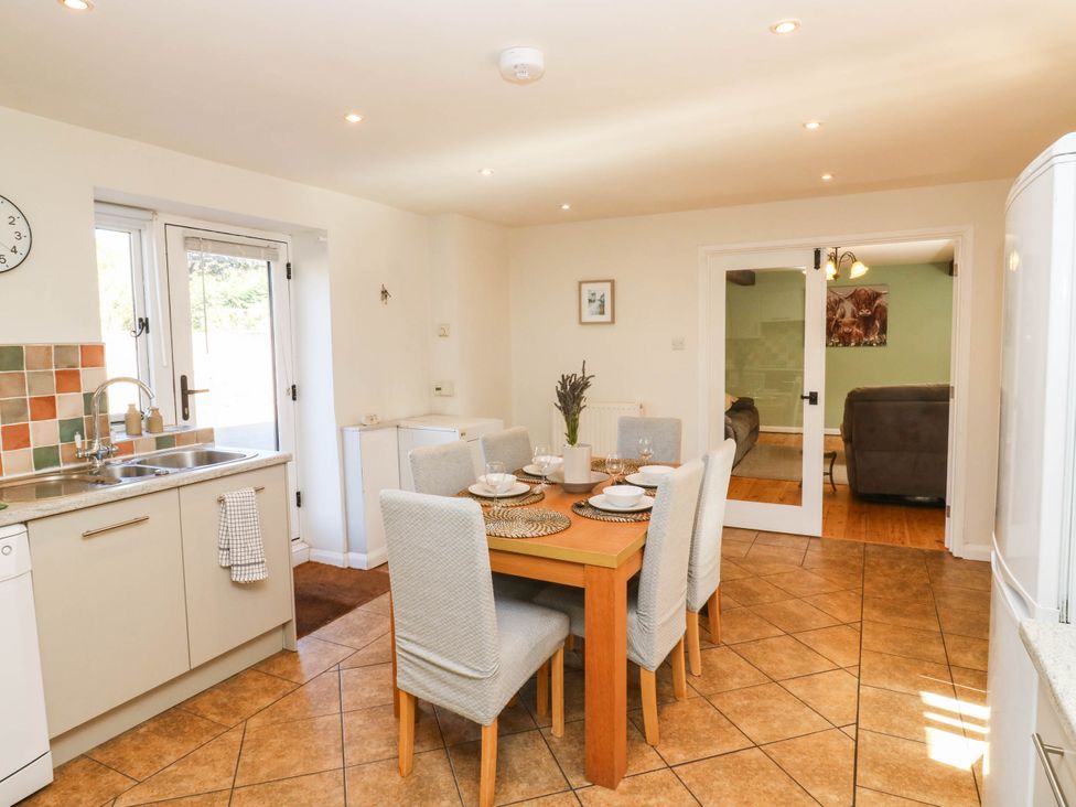 A kitchen with a dining table and chairs at 3 Town Farm Court in Newton Abbot