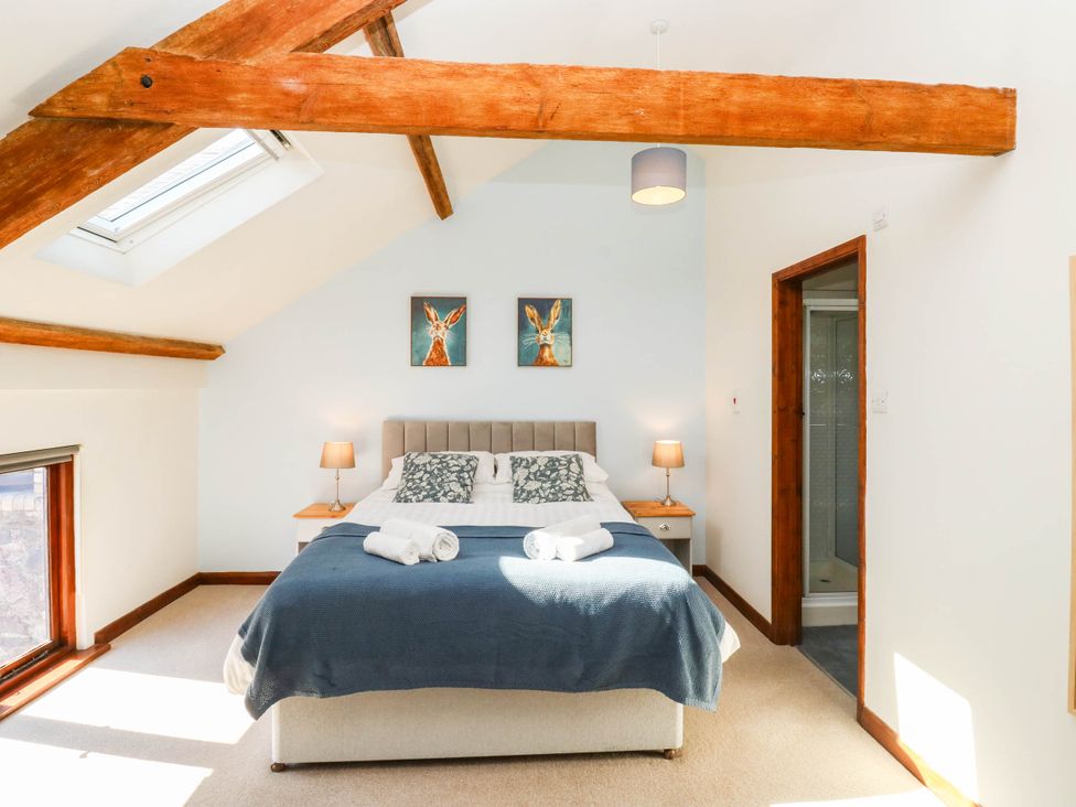A bedroom with a bed and bedside table at 3 Town Farm Court Newton Abbot