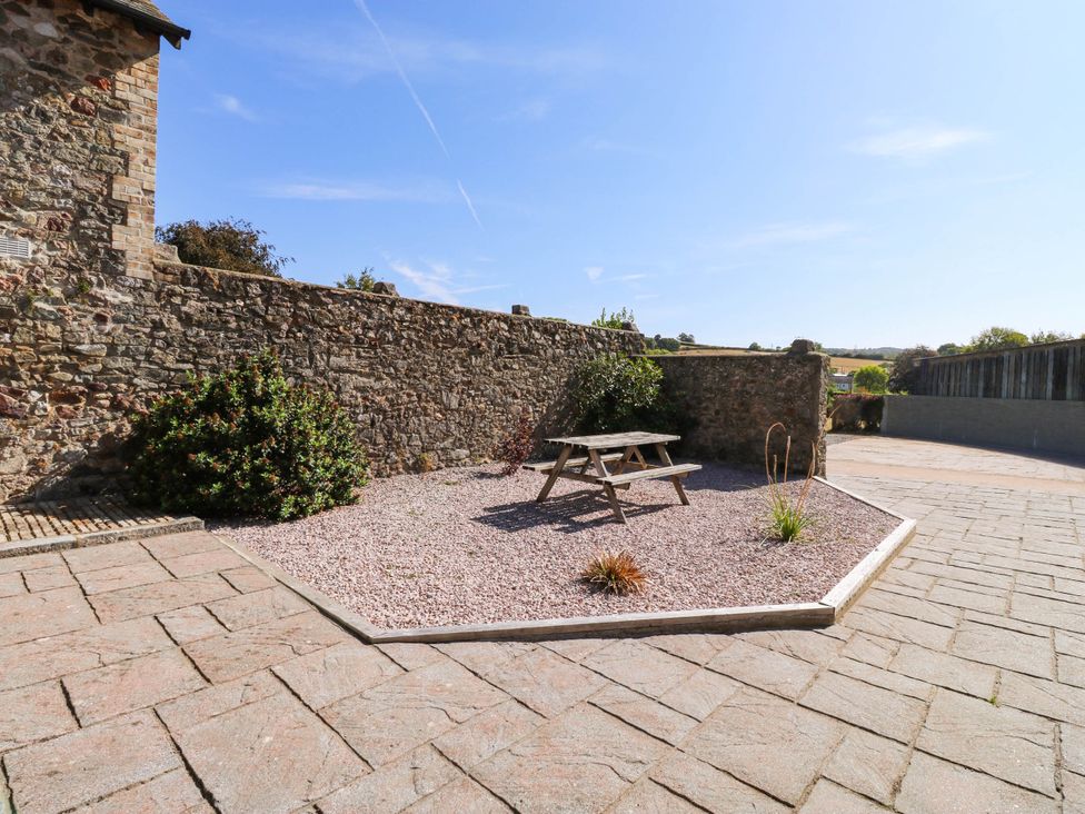 An outdoor space with a picnic table and gravel at 3 Town Farm Court Newton Abbot