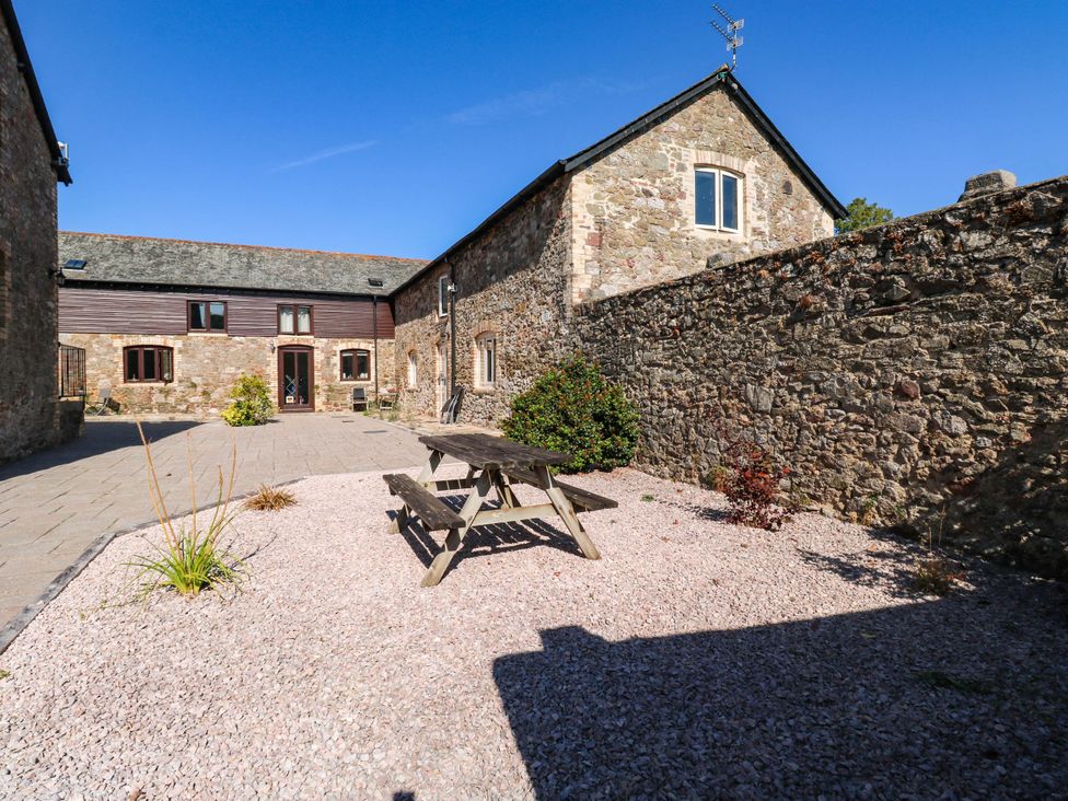 A garden with a picnic table at 3 Town Farm Court in Newton Abbot