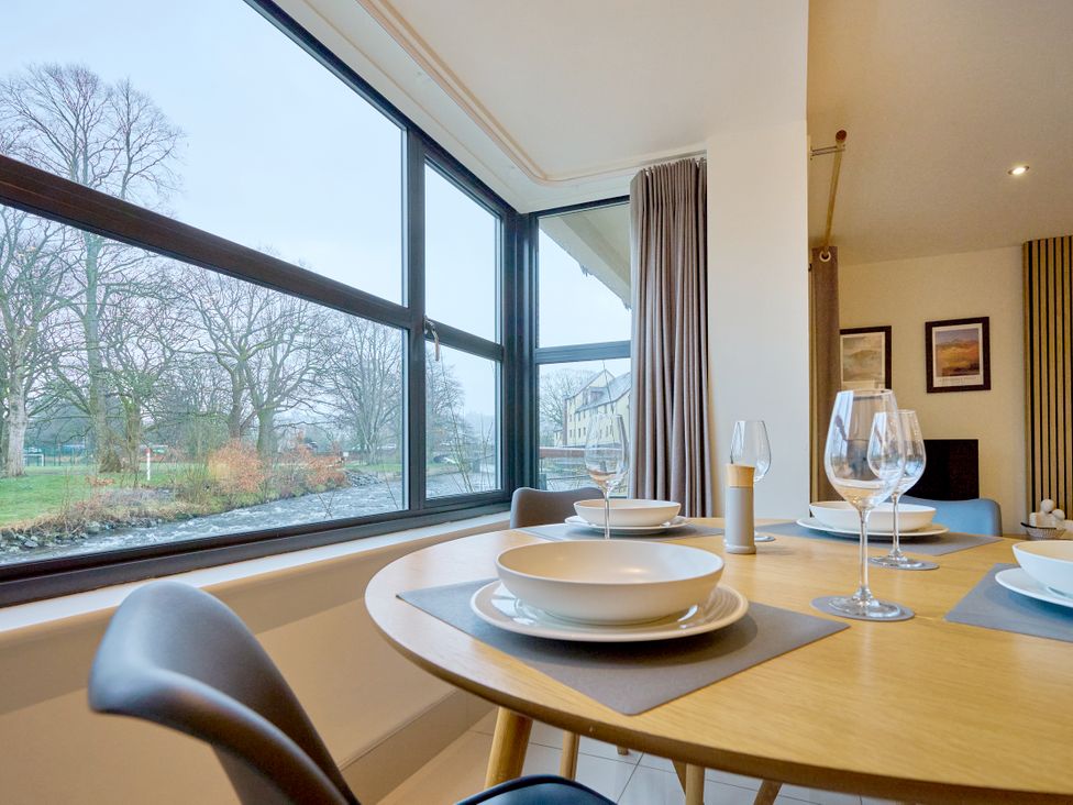 A dining room with a table set for meals at Riverside Park 1 in Keswick