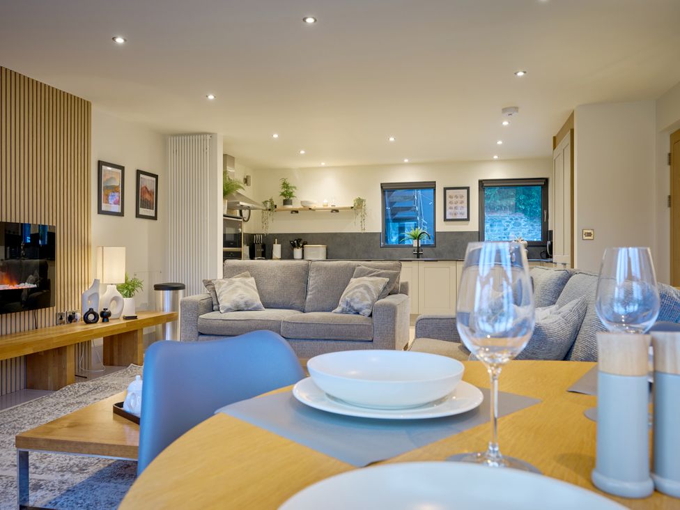 A living room with a sofa and dining table at Riverside Park 1 in Keswick