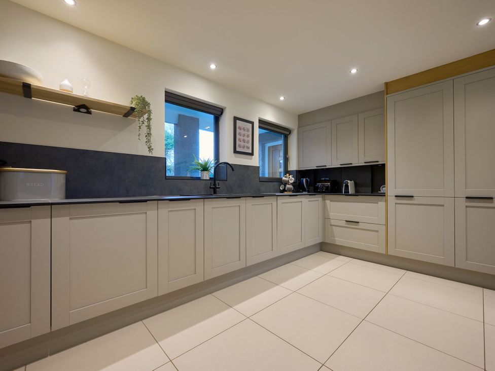 A kitchen with cabinets, sink, and appliances at Riverside Park 1 in Keswick