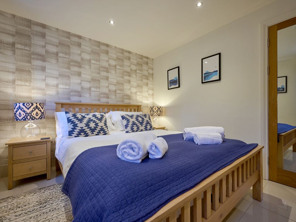 A bedroom with a bed and bedside table at Riverside Park 1 in Keswick