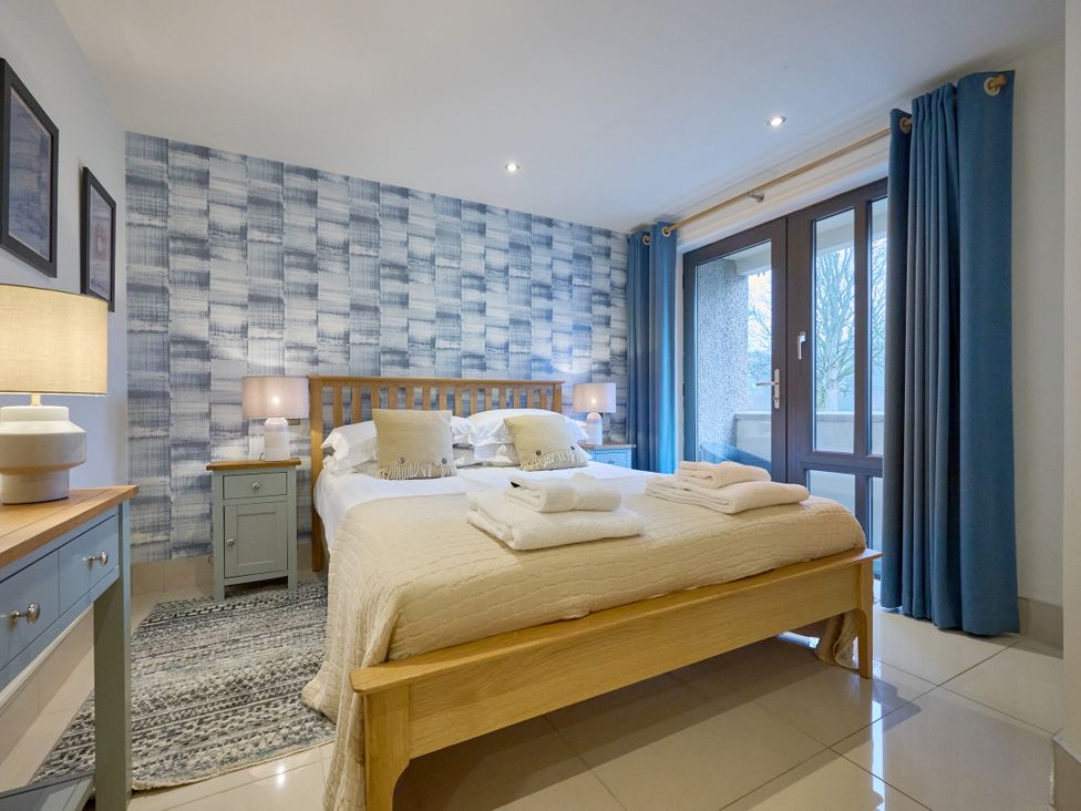 A bedroom with a bed and nightstand at Riverside Park 1 in Keswick